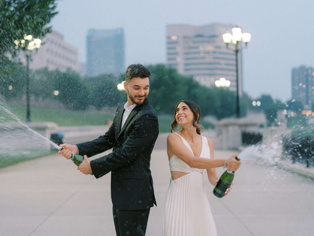 Spraying champagne along the Scioto Mile following Ana & Stephen's engagement session in downtown Columbus