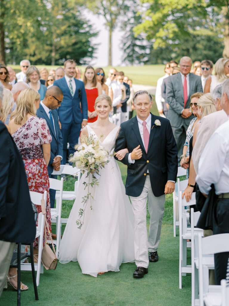 An outdoor wedding ceremony on the tenth green at Kirtland Country Club